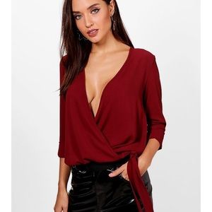 Lucy wrap around blouse in the color burgundy.